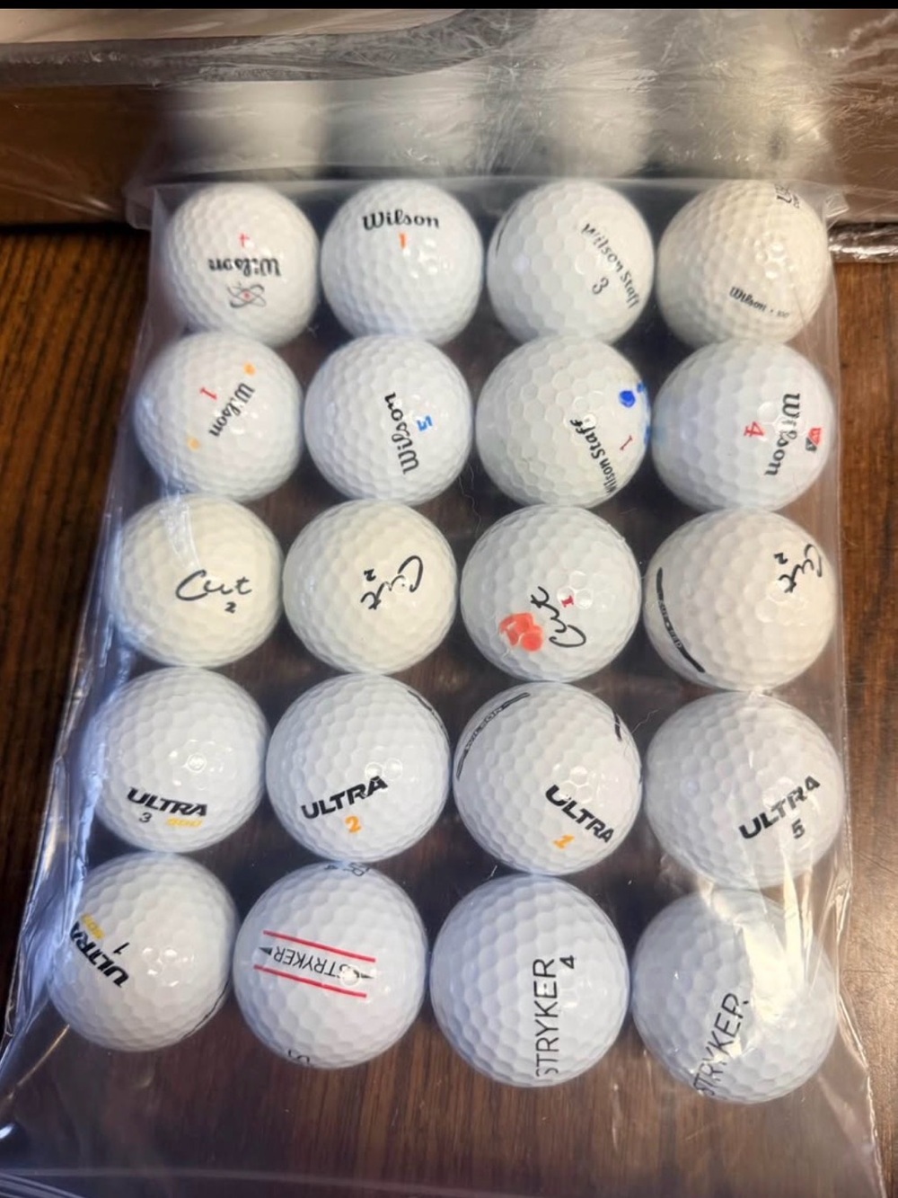 20 assorted used golf balls - Wilson, Cut, Ultra, and Stryker